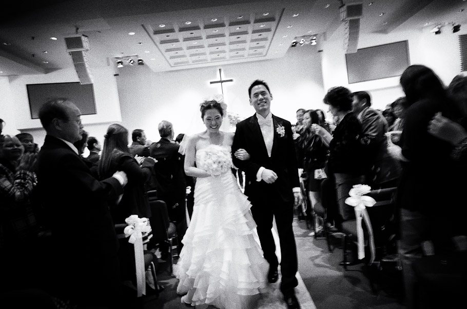 The newly weds walking down the aisle leaving the sanctuary