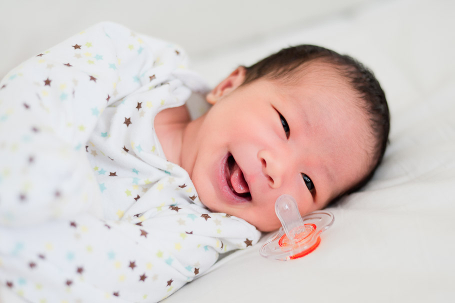 One of the first smiles. He has never liked binkies and always spat them out.